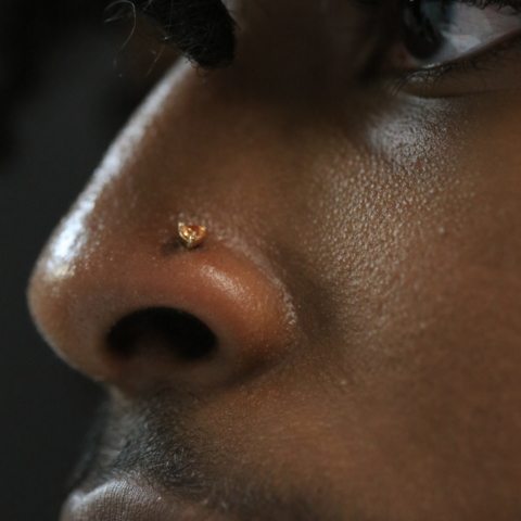 nose piercing with 14k gold heart with champagne stone by junipurr body jewelry