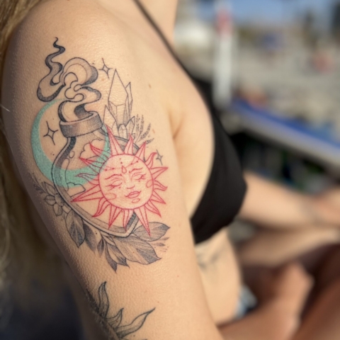 Tatuaje de botella mágica con Sol, Luna y cristales