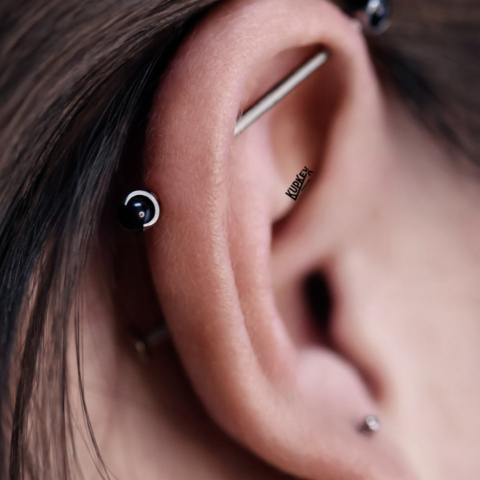 industrial piercing with black claw gem ends